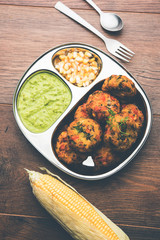 Crispy Corn Tikki, pakora/pakoda or pattice also known as cutlet. served with green chutney. Selective focus