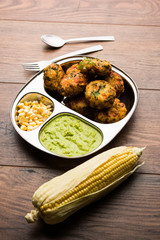 Crispy Corn Tikki, pakora/pakoda or pattice also known as cutlet. served with green chutney. Selective focus