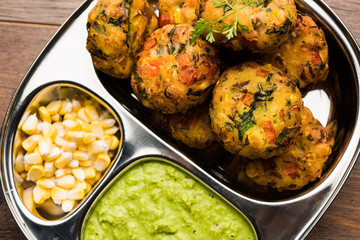 Crispy Corn Tikki, pakora/pakoda or pattice also known as cutlet. served with green chutney. Selective focus
