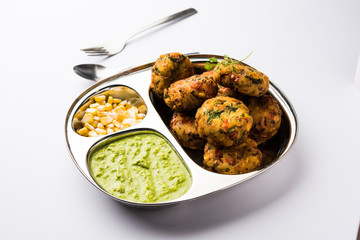 Crispy Corn Tikki, pakora/pakoda or pattice also known as cutlet. served with green chutney. Selective focus