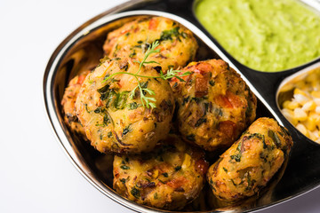 Crispy Corn Tikki, pakora/pakoda or pattice also known as cutlet. served with green chutney. Selective focus