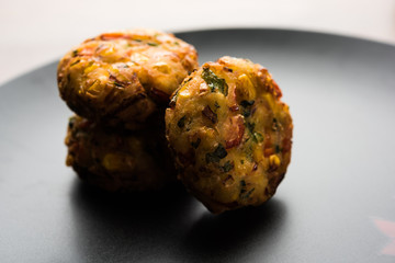 Crispy Corn Tikki, pakora/pakoda or pattice also known as cutlet. served with green chutney. Selective focus