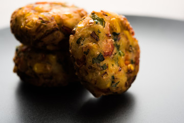 Crispy Corn Tikki, pakora/pakoda or pattice also known as cutlet. served with green chutney. Selective focus