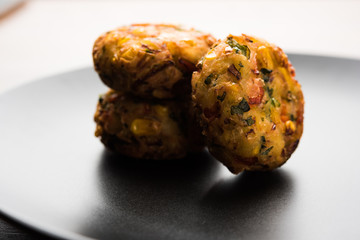 Crispy Corn Tikki, pakora/pakoda or pattice also known as cutlet. served with green chutney. Selective focus