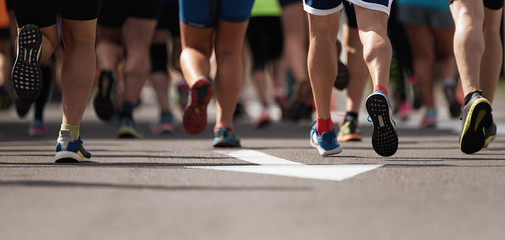 Marathon running race, people feet on city road