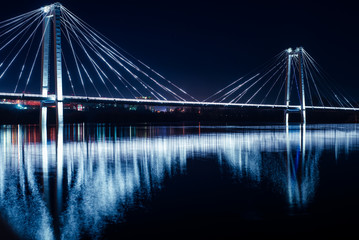 Bridge over the Yenisei river, with night lighting. The concept of the city at night.