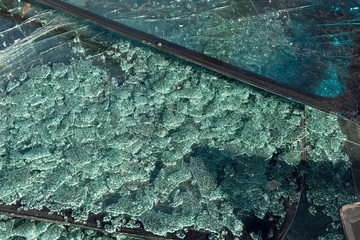 Naklejka premium Broken cars windshields on pieces. 