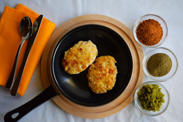 Delicious fried cutlets with spices in a frying pan.