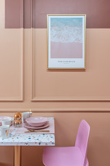 Dining corner with terrazzo top table and baby pink chair and decoration prop on the table with old rose painted wall on the background / interior design concept / studio shot