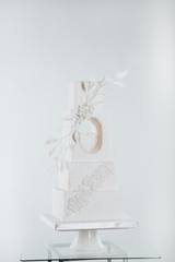 Beautiful wedding cake decorated with flowers. white wedding flower cake on the table.