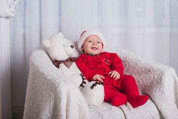 Obraz premium Beautiful baby Christmas photo shoot- studio photo. Little santa. Happy New Year .