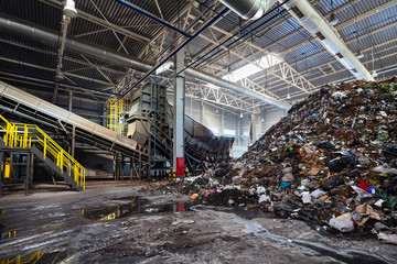 Solving problem of environmental pollution with waste as garbage processing plant - huge pile of garbage prepared for loading to conveyor belt for sorting and processing