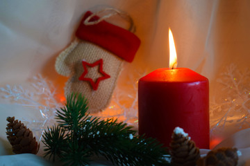 Christmas candles and green twigs on the background of lights.