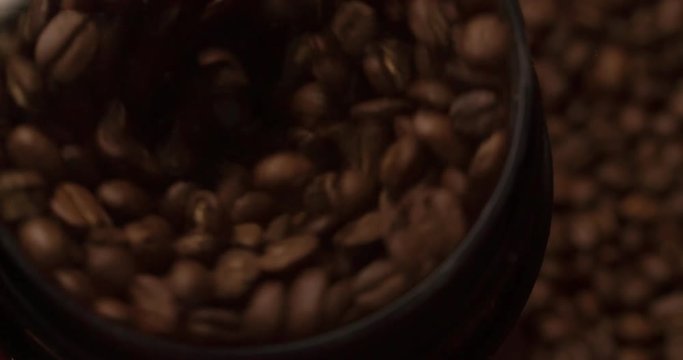 Coffee mill grinder grinds coffee beans close up macro shot Slow Motion top view video