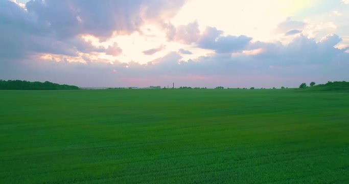 green field at sunset aerial 4k 50p move forevard