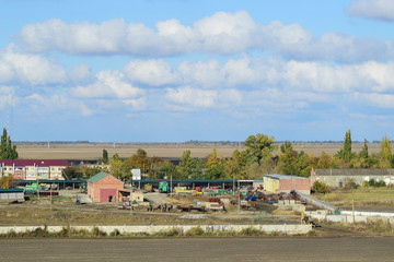 A view from above of a small Russian village. Rural landscape. Field and village. A semi-abandoned village