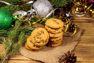 Chocolate chip cookies with Christmas decoration on wooden table