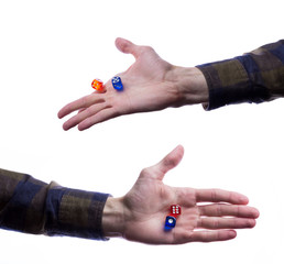 Board game concept - hand holding plastic board game dice isolated on white background.