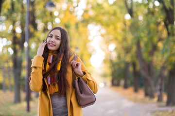 Young Woman walks in autumn park