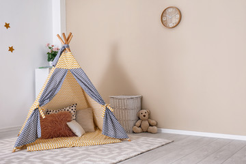Cozy kids room interior with play tent and toys. Space for text © New Africa