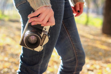 Vintage camera in hand of young photographer and ready to take photo