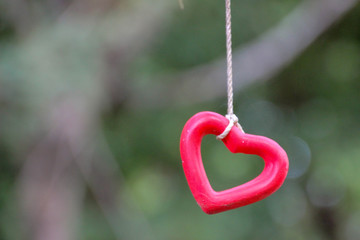 Red heart rope Natural bokeh is the background, Valentine's Day concept and love.
