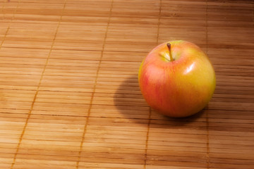 apple on wooden napkin, with copy space.