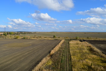 plowed field in the spring in the village. Agricultural land in the Kuban. Preparation of fields for sowing wheat