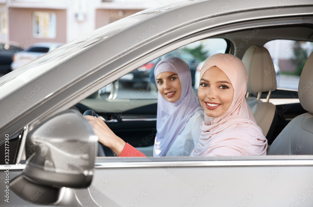 Canvas Prints Female Muslim driver and her friend in car