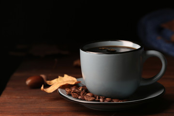 Composition with cup of hot cozy drink and autumn leaves on table. Space for text