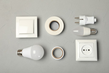 Flat lay composition with electrician's tools on gray background