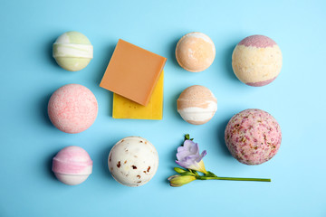 Flat lay composition with bath bombs and soap bars on color background