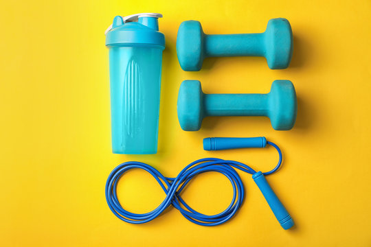 Flat lay composition with jump rope on color background