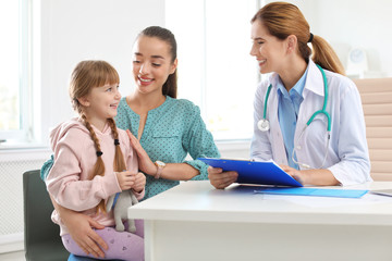 Little girl with parent visiting children's doctor in hospital