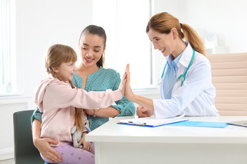 Little girl with parent visiting children's doctor in hospital