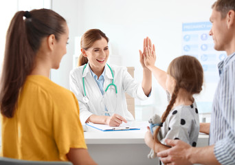 Parents with little daughter visiting children's doctor in hospital