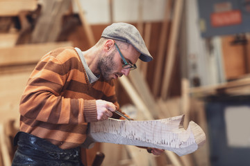 Carpenter working on wooden forcola for venetian gondola © guerrieroale