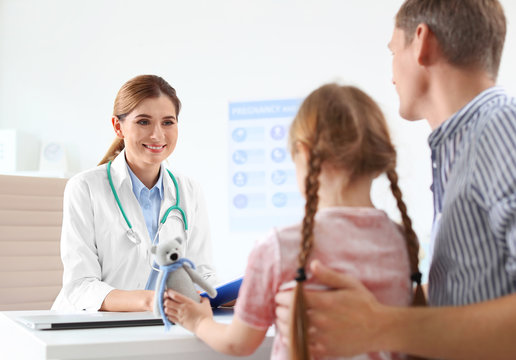 Little girl with parent visiting children's doctor in hospital