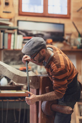 Carpenter working on wooden forcola for venetian gondola