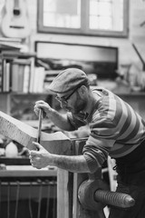 Carpenter working on wooden forcola for venetian gondola
