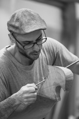 Carpenter working on wooden forcola for venetian gondola