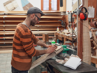 Carpenter marking the detail in workshop