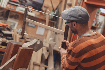 Carpenter sawing wooden detail