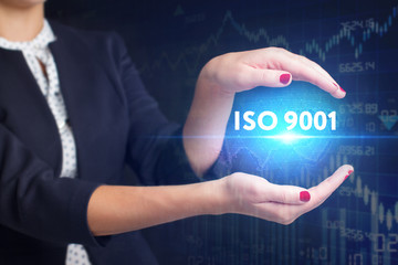 The concept of business, technology, the Internet and the network. A young entrepreneur working on a virtual screen of the future and sees the inscription: ISO 9001