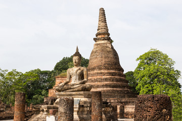 Fototapeta premium The old Buddha image on cement with ruins and ancient, Built in modern history in historical park is the UNESCO world heritage, Sukhothai Thailand.