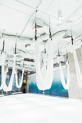 Light white spacious studio equipped for aerial yoga