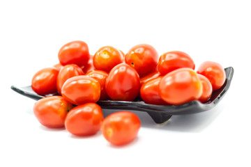 Fresh Tomato in a ceramic cup isolated white background 