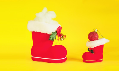 Red Christmas boot with gift on color background.