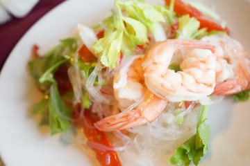 Spicy seafood salad. A closed up of Thai glass noodle salad with shrimp or Yum Woon Sen. Selective focus on prawn. © enchanted_fairy
