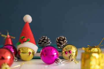 Christmas concept with copy space.Ornament balls, Santa Claus hat and note book with blue background.